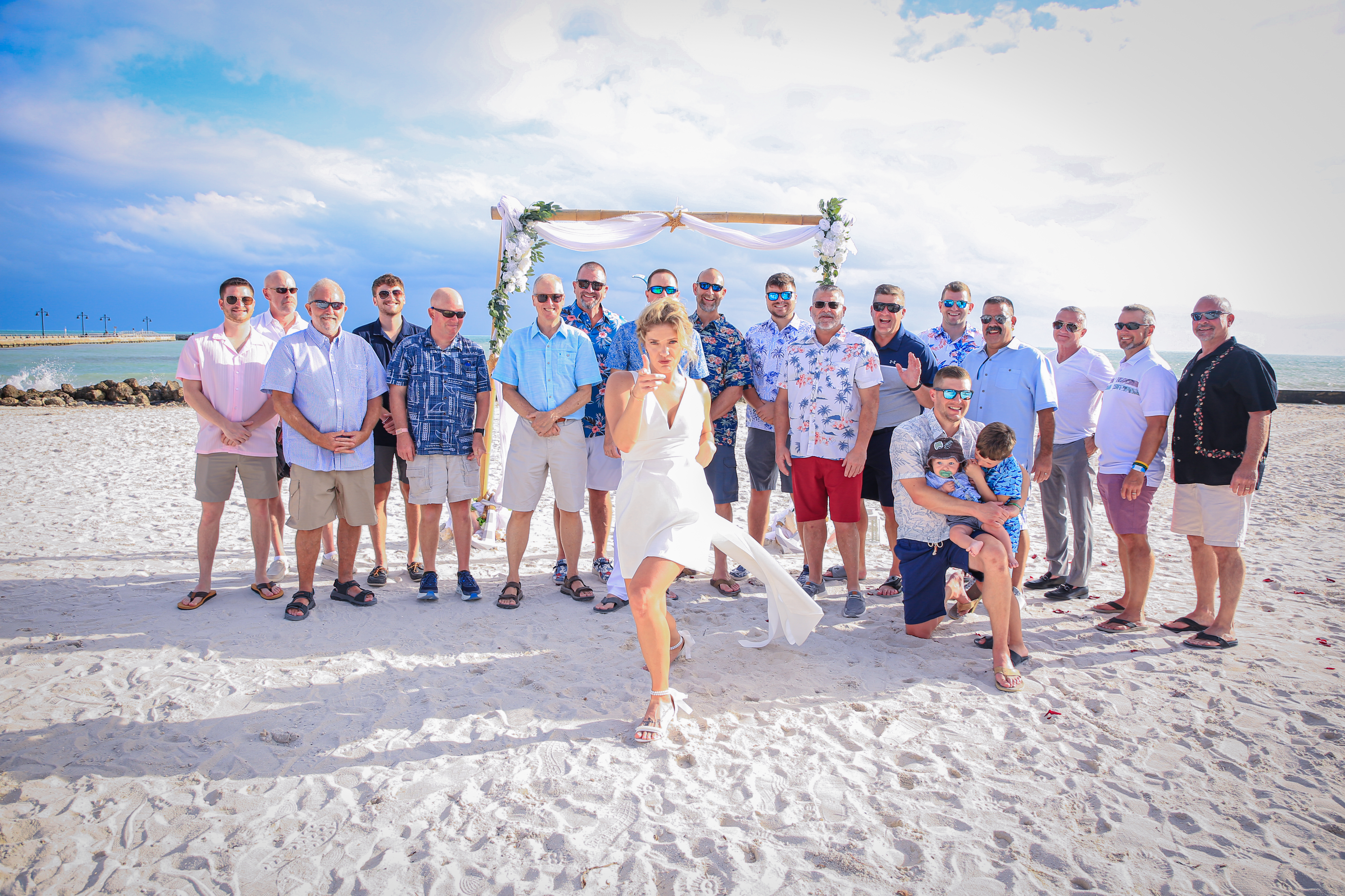 Wedding Couple make a heart in front of the setting sun with their hands