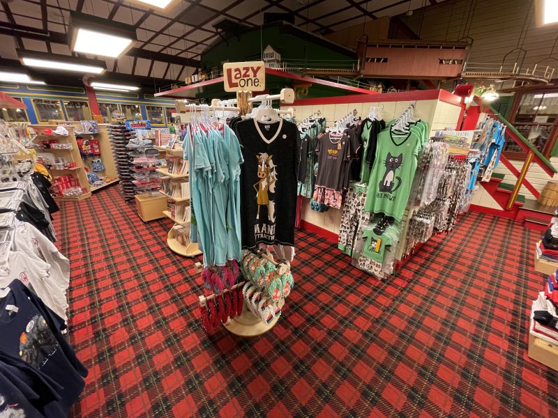 several racks of sweaters inside a store