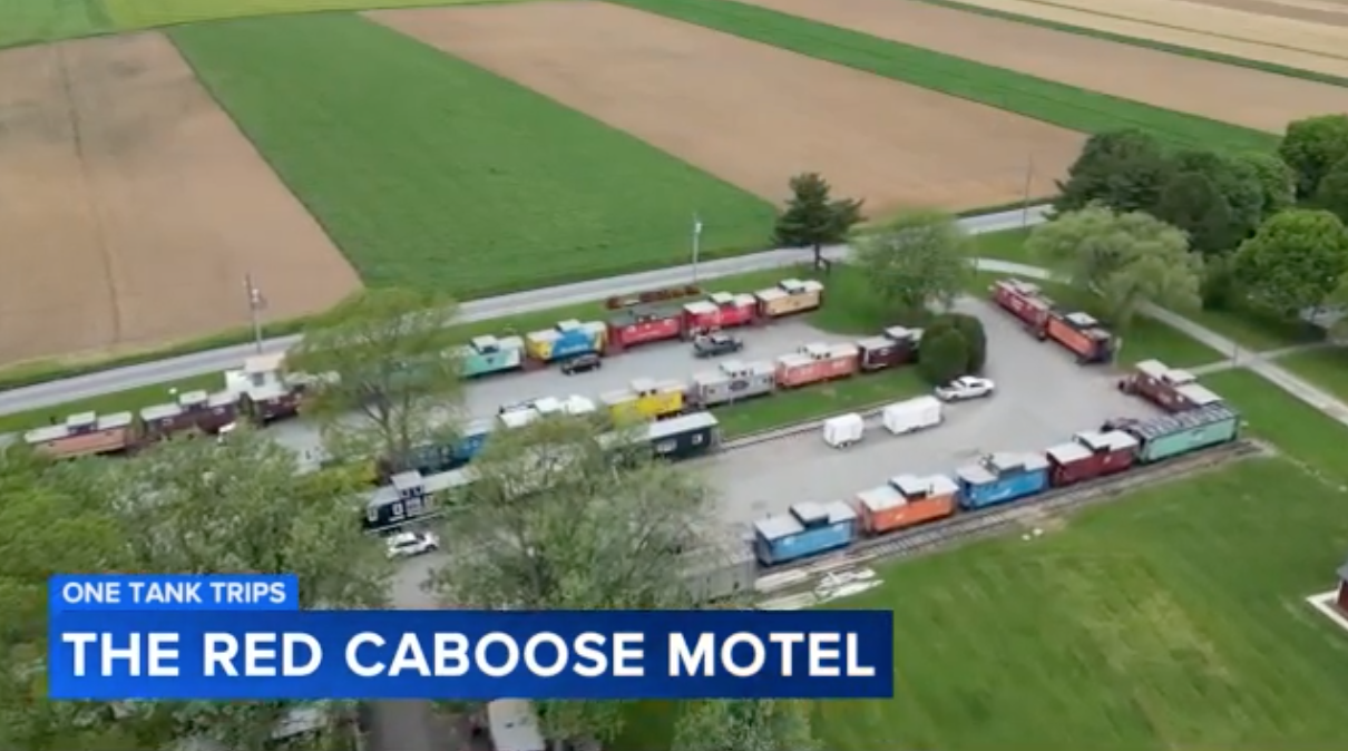 red train caboose featuring big sign for Red Caboose Motel