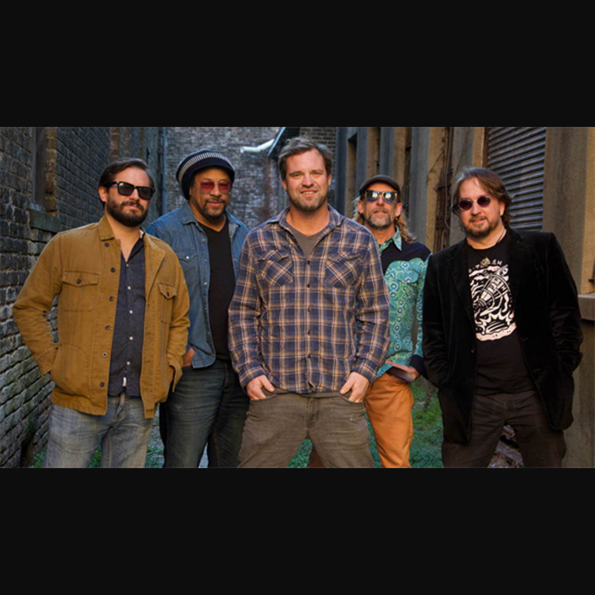 five men standing shoulder to shoulder